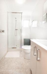a white bathroom with a shower and a toilet at EDIFICIO CHAPARIL in Nerja
