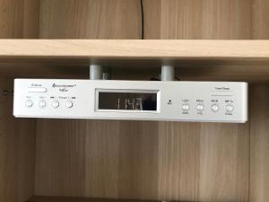 a microwave on a shelf on a wooden wall at B&B De Spiegel - Genieten van rust en ruimte in Cothen