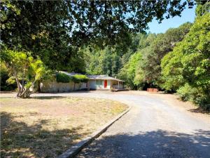 a house on the side of a road at Reflections! Seasonal Dock & Kayaks!! Hot Tub!! Fire Table! BBQ! HUGE yard! Horseshoes! Dog Friendly! in Guerneville