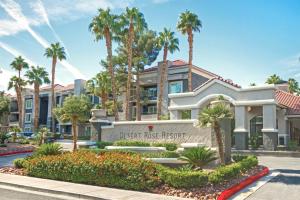 a building at the desert ridge resort with palm trees at Desert Rose Resort in Las Vegas