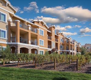 an apartment building with a row of vines at Vino Bello Resort in Napa