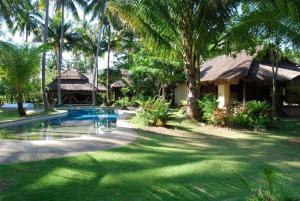 a resort with a swimming pool and palm trees at Koyao Bay Pavilions - SHA Extra Plus in Ko Yao Noi
