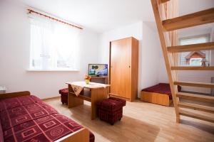 a bedroom with a bunk bed and a staircase at Pensjonat Bogdanka in Trzęsacz
