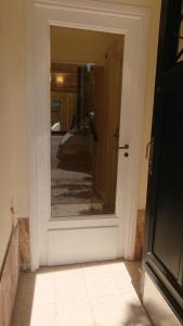 a door with a reflection of a car in a window at 534 Petit San Telmo - Studio & Suites in Buenos Aires +29 photos