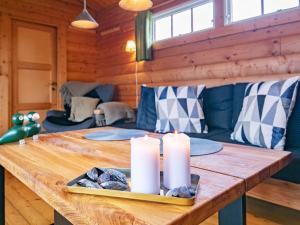 a wooden table with candles on it in a room at 4 person holiday home in Assens in Assens