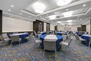 uma sala de conferências com mesas e cadeiras azuis em Holiday Inn Express & Suites Memorial – CityCentre, an IHG Hotel em Houston