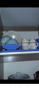 a shelf with a bunch of dishes and pans at Urban Deca Tower Graceysplace Unit unit 3113 Mandaluyong in Manila