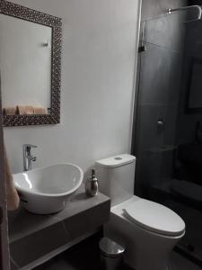 y baño con aseo, lavabo y espejo. en Estancia Real en Morelia