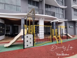 a playground in front of a building with a slide at Troika Residence Kota Bharu @ Eternity Live-1B4pax in Kota Bharu