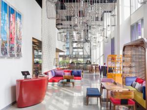 a lobby with colorful furniture and a chandelier at Wink Hotel Saigon Centre in Ho Chi Minh City