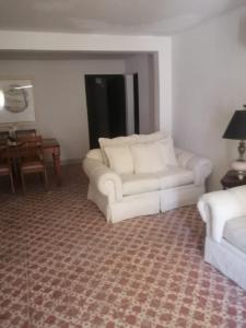 a living room with two white couches and a table at Brenda Alicia 2 in Puerto Peñasco