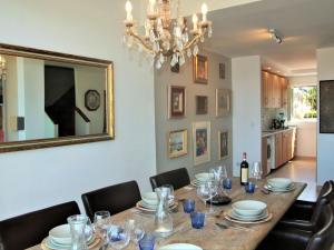 a dining room with a table with chairs and a chandelier at Belvilla by OYO Casa Alegr a in Galapagar