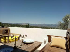 a patio with a table and a view of the mountains at Belvilla by OYO Casa Alegr a in Galapagar