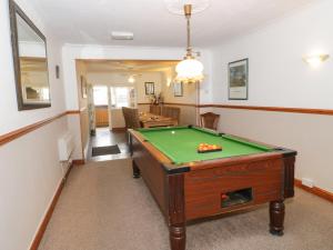 a living room with a pool table in it at Beach Bungalow in Rhyl