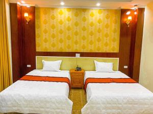 Un pat sau paturi într-o cameră la An Khang Hotel