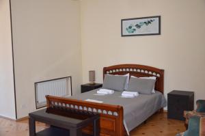 a bedroom with a bed with two towels on it at Borjomi Sichi in Borjomi
