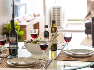 a table with glasses of wine and a bowl of food at Blue Vista in Gerringong