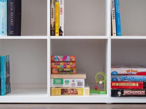 a white book shelf filled with lots of books at Blue Vista in Gerringong +15 photos
