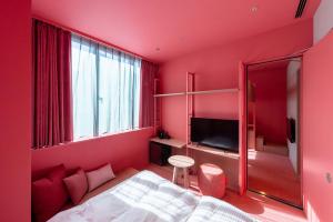 
a room with a bed, a mirror, and a window at toggle hotel suidobashi TOKYO in Tokyo
