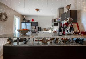a kitchen with a counter top with bottles of wine at lamaison-d'ose in Romans