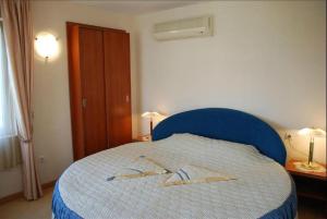 a bedroom with a blue bed with two towels on it at Italia Hotel in Nesebar