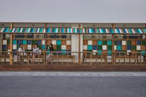a building with stained glass windows and people sitting on benches at HOTEL tuka miika in Ishigaki Island