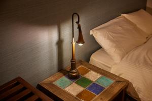 a lamp on a table next to a bed at HOTEL tuka miika in Ishigaki Island