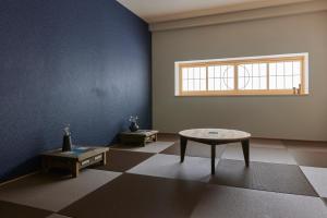 an empty room with a table and a window at HOTEL tuka miika in Ishigaki Island