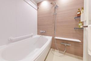 a bathroom with a bath tub and a shower at hotel MONday KYOTO MARUTAMACHI in Kyoto