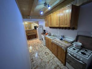 a kitchen with wooden cabinets and a stove top oven at Freemont in Braşov