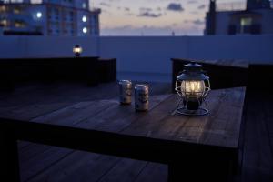 a table with a lantern and two cans on it at HOTEL tuka miika in Ishigaki Island +53 photos
