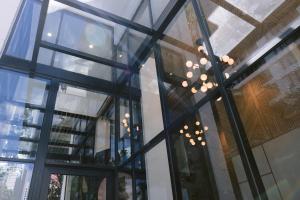 a glass facade of a building with a chandelier at Indie Hotel Kuala Lumpur in Kuala Lumpur