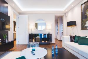 a living room with a white couch and a table at Majestic Apartment in Jagodina