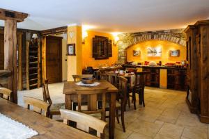 a kitchen and dining room with wooden tables and chairs at Clé du Paradis in Bionaz +25 photos