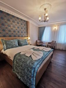 a bedroom with a large bed with a chandelier at Agora Boutique Hotel & Bistro in Istanbul
