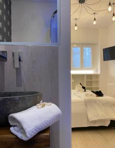 a bathroom with a tub and a bed in a room at Camera Olimpia in Deiva Marina