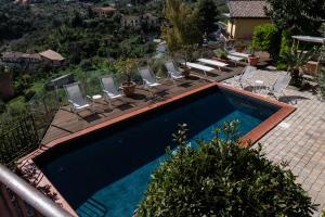 a swimming pool with lounge chairs at BnB Casa Rossa in Monreale