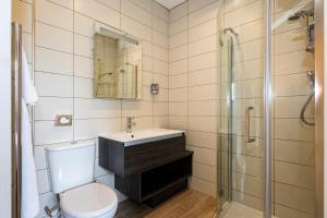 a bathroom with a toilet and a sink and a shower at White House in St Asaph