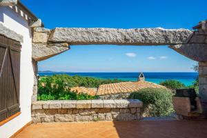 a view of the ocean from the porch of a house at BGItalianVacation - Ville di Rocca Sant'Elmo in Castiadas