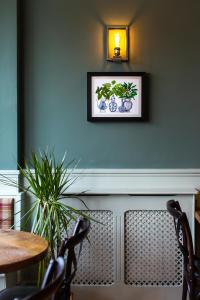 a dining room with a table and chairs and a picture on the wall at Coach House Inn in Dorchester