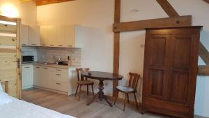 a kitchen with a table and chairs in a room at Dziewanna in Brzeziniec
