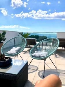 two chairs and a table on a balcony at Bubbles Penthouse with Jacuzzi in Podstrana