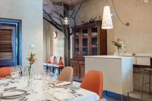 a dining room with a table with orange chairs at Aura del Jerte in Jerte