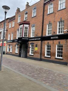 a brick building with a hotel on a street at Gainsborough Hotel in Gainsborough