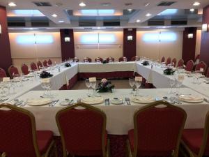 a meeting room with long tables and chairs at Perla Marina in Nerja