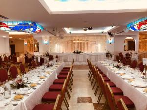 a large banquet hall with long tables and chairs at Perla Marina in Nerja