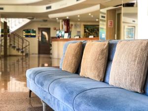 a blue couch with two pillows on top of it at Perla Marina in Nerja