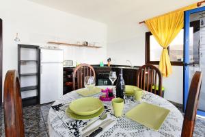a dining room with a table and a kitchen at Vista Mejía 1 in Caleta de Caballo
