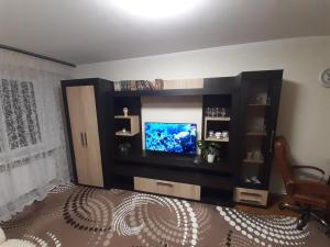 a living room with a flat screen tv on a wall at Двокімнатна in Shepetivka +5 photos