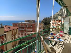 a balcony with a table and a view of the ocean at Giulia & Giovanna Apartments in Levanto